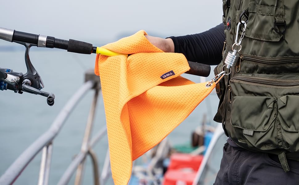 OHIKA microfiber fishing towel cleaning a fishing pole orange